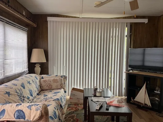 a living room with furniture a lamp and a window