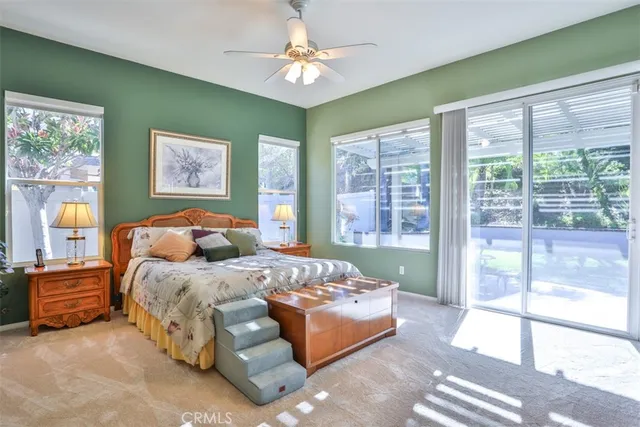 a bedroom with a bed and a large window