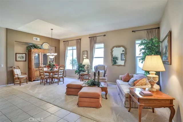 a living room with furniture a lamp and a large window