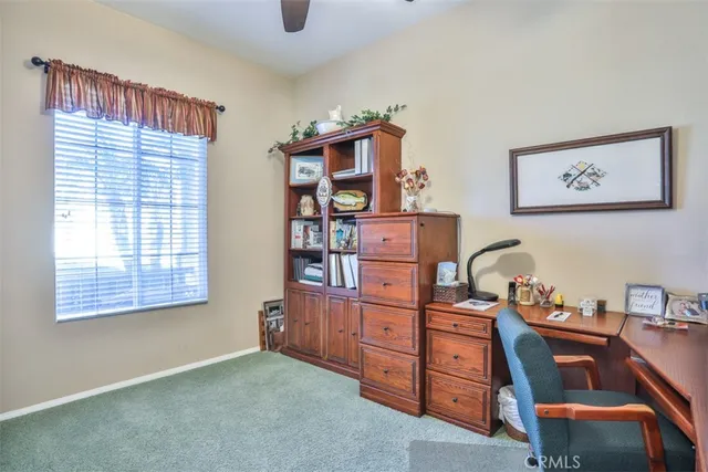 a view of a workspace with furniture and cabinet