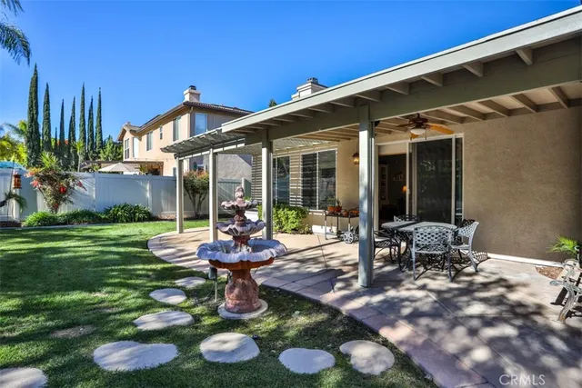 a front view of a house with a yard table and chairs