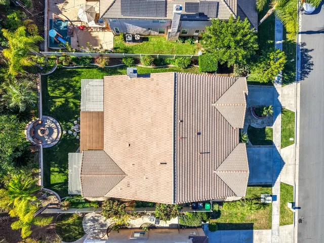 an aerial view of a city with lots of residential buildings and mountain view in back