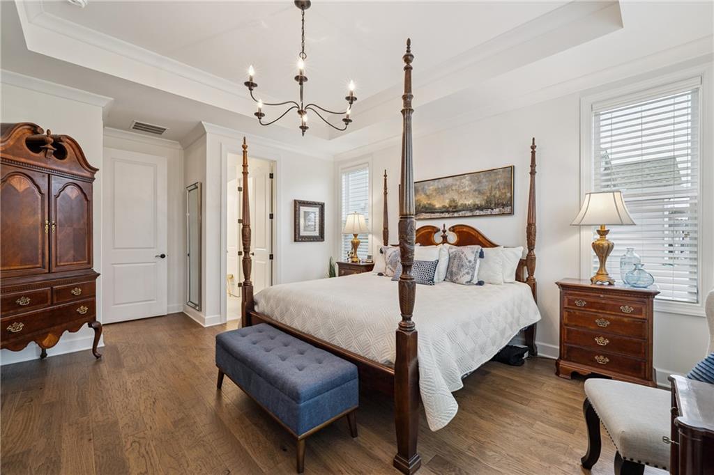 103 Rabun Court Hoschton, GA 30548 - Photo 13 of 22 a bedroom with a bed chandelier and a window