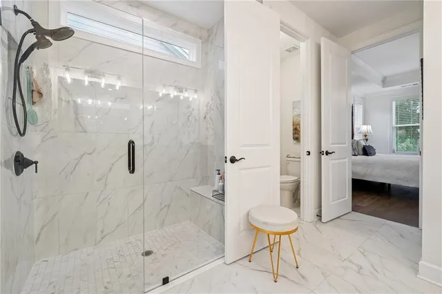 a bathroom with a shower and a toilet