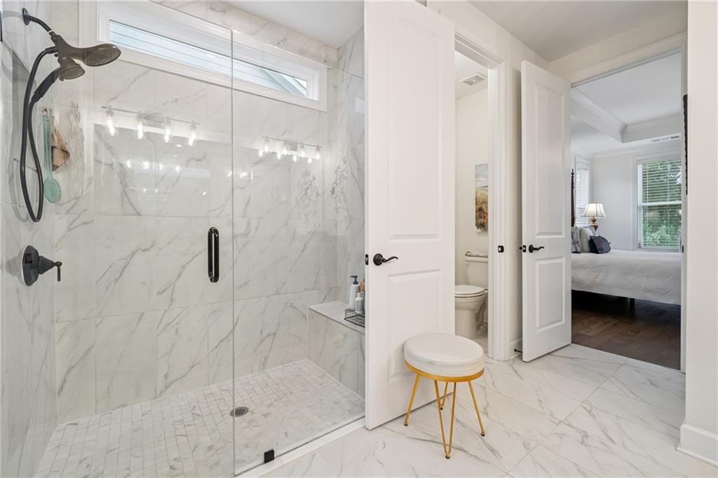 103 Rabun Court Hoschton, GA 30548 - Photo 15 of 22 a bathroom with a shower and a toilet