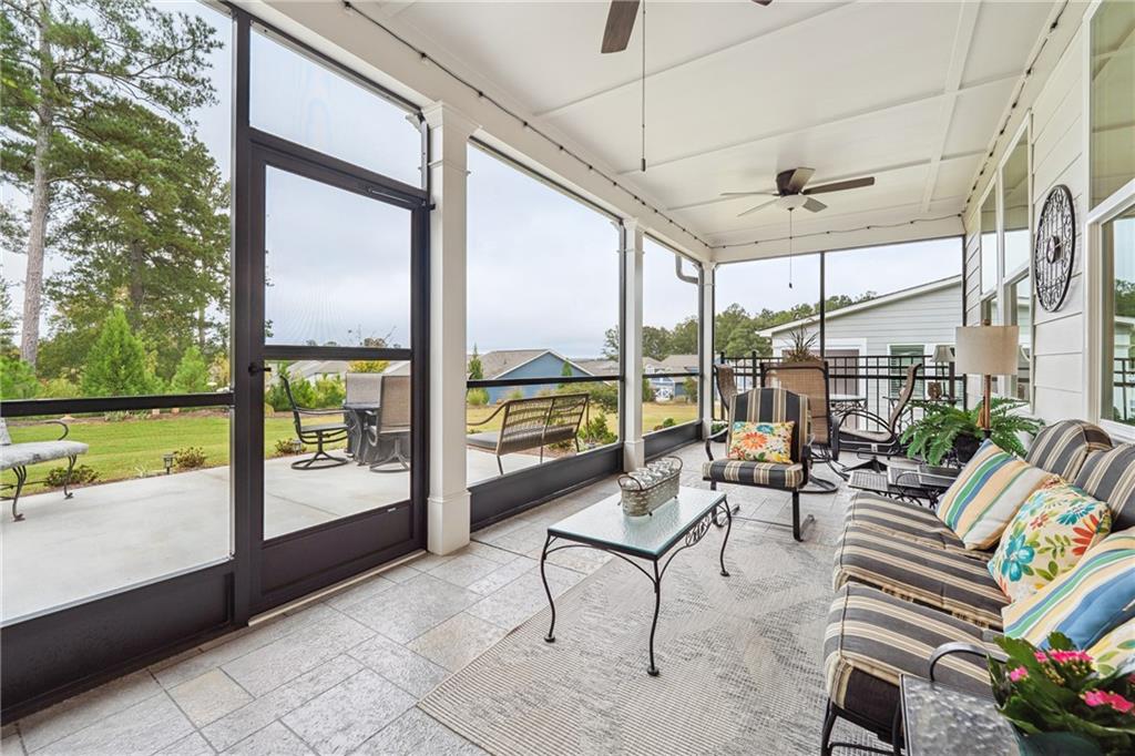 103 Rabun Court Hoschton, GA 30548 - Photo 20 of 22 a living room with patio furniture and garden view