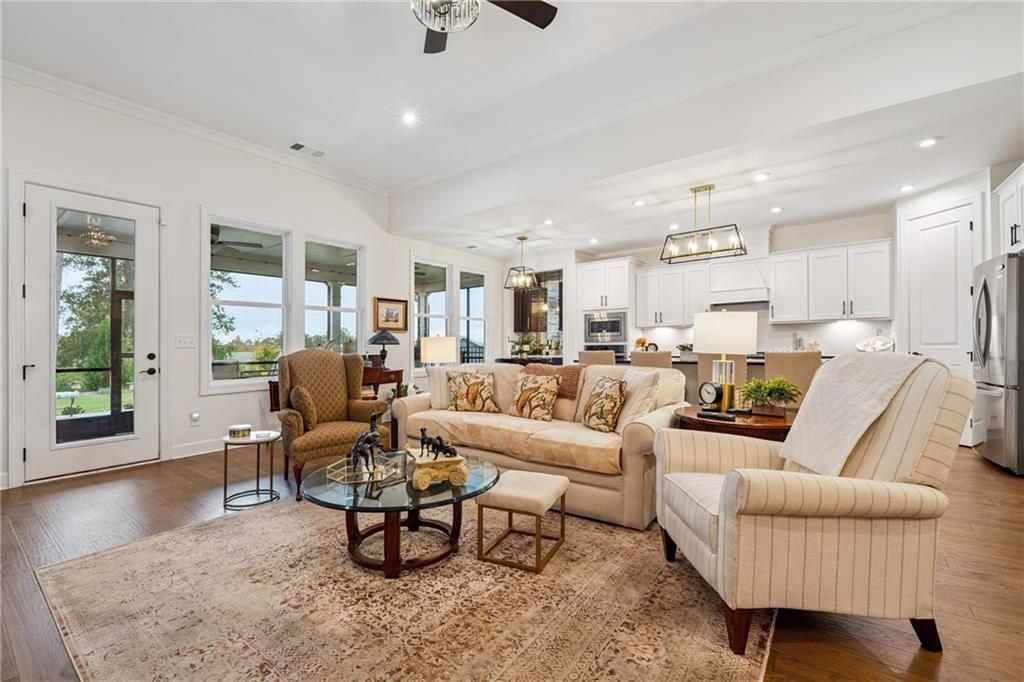 103 Rabun Court Hoschton, GA 30548 - Photo 5 of 22 a living room with furniture wooden floor and a large window