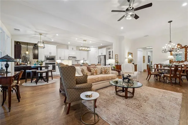a living room with lots of furniture and kitchen view