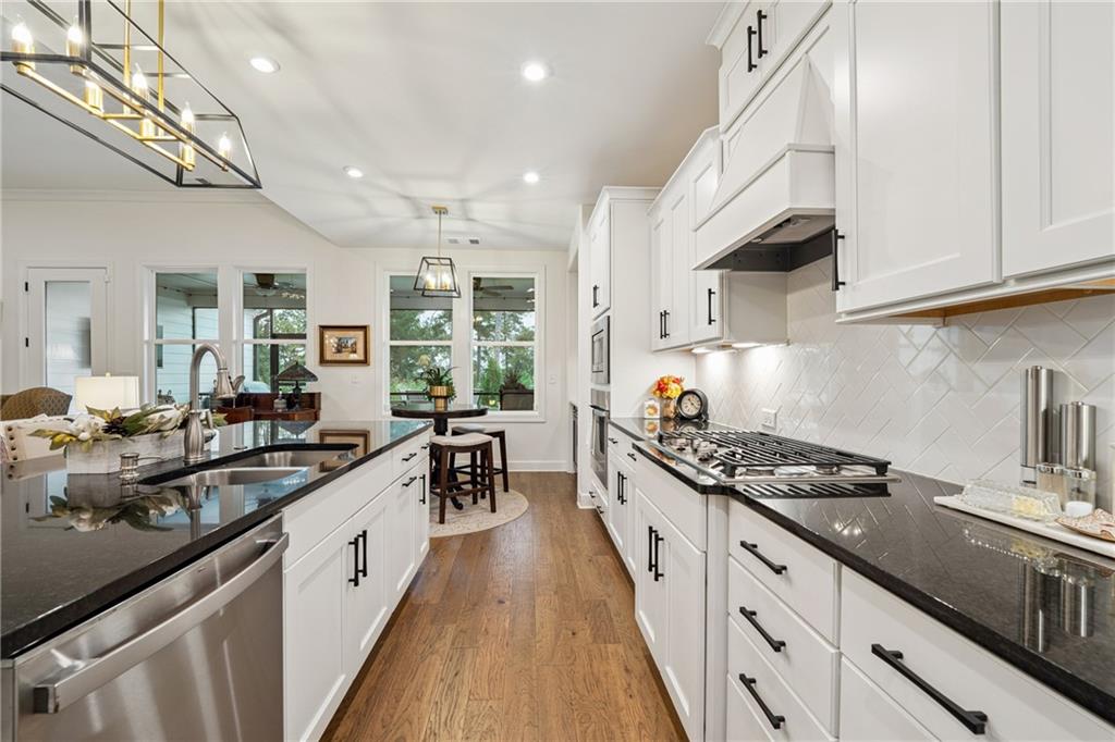 103 Rabun Court Hoschton, GA 30548 - Photo 8 of 22 a kitchen with granite countertop a sink stove and cabinets