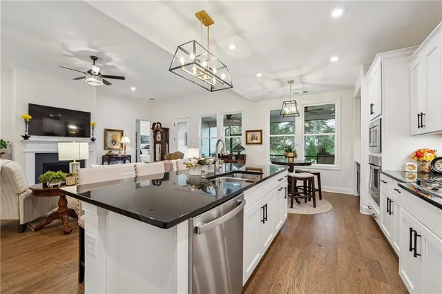 a kitchen with a counter space a sink appliances and a counter top space