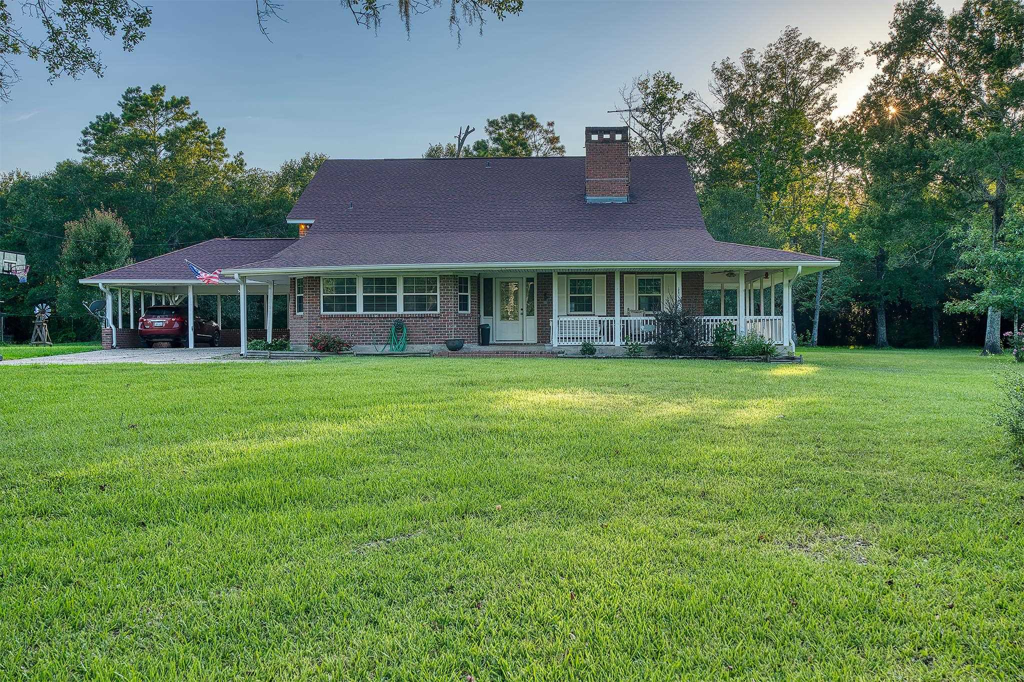 7476 Foard Road Beaumont, TX 77705 - Photo 1 of 49 a view of a house with a big yard and large trees