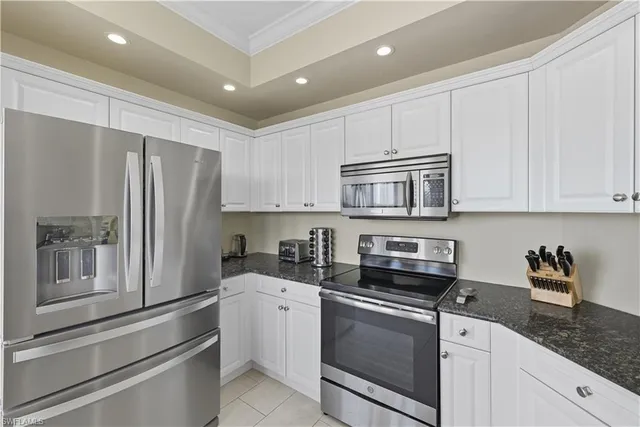a kitchen with stainless steel appliances granite countertop a refrigerator sink and cabinets