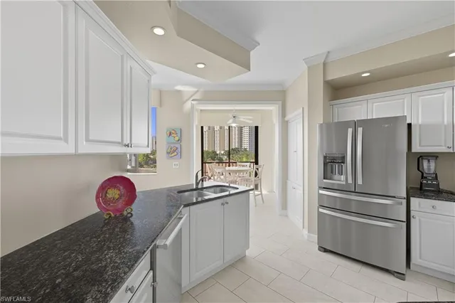 a kitchen with stainless steel appliances granite countertop a refrigerator and a sink