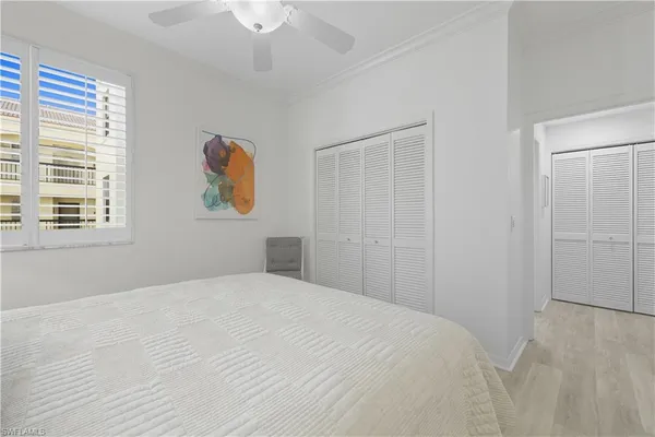 a large bed sitting in a bedroom next to a lamp
