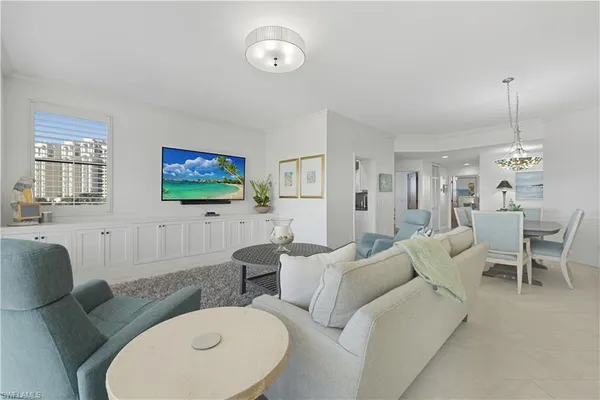 a living room with furniture a dining table and a fireplace