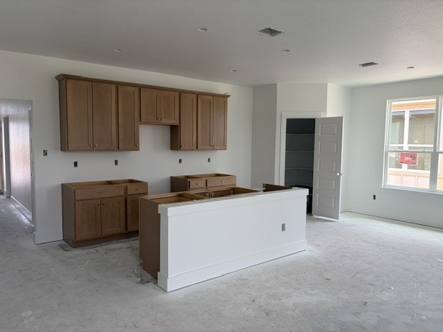 544 Gus Loop Georgetown, TX 78626 - Photo 3 of 22 a kitchen with stainless steel appliances a refrigerator and a stove top oven