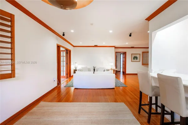 a large room with wooden floor and furniture