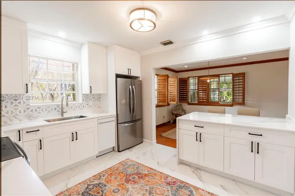 a kitchen with a sink stove and refrigerator