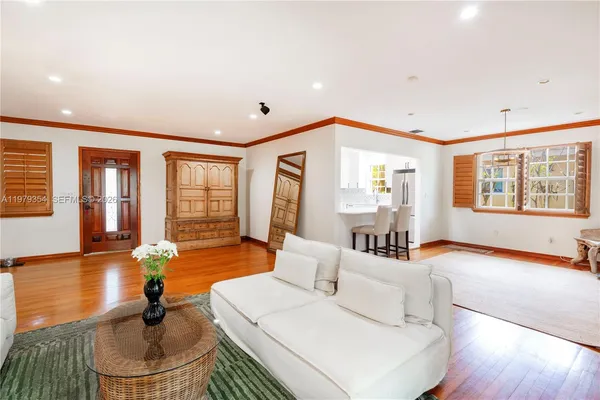 a living room with fireplace furniture and a large window