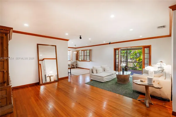 a living room with furniture and a wooden floor