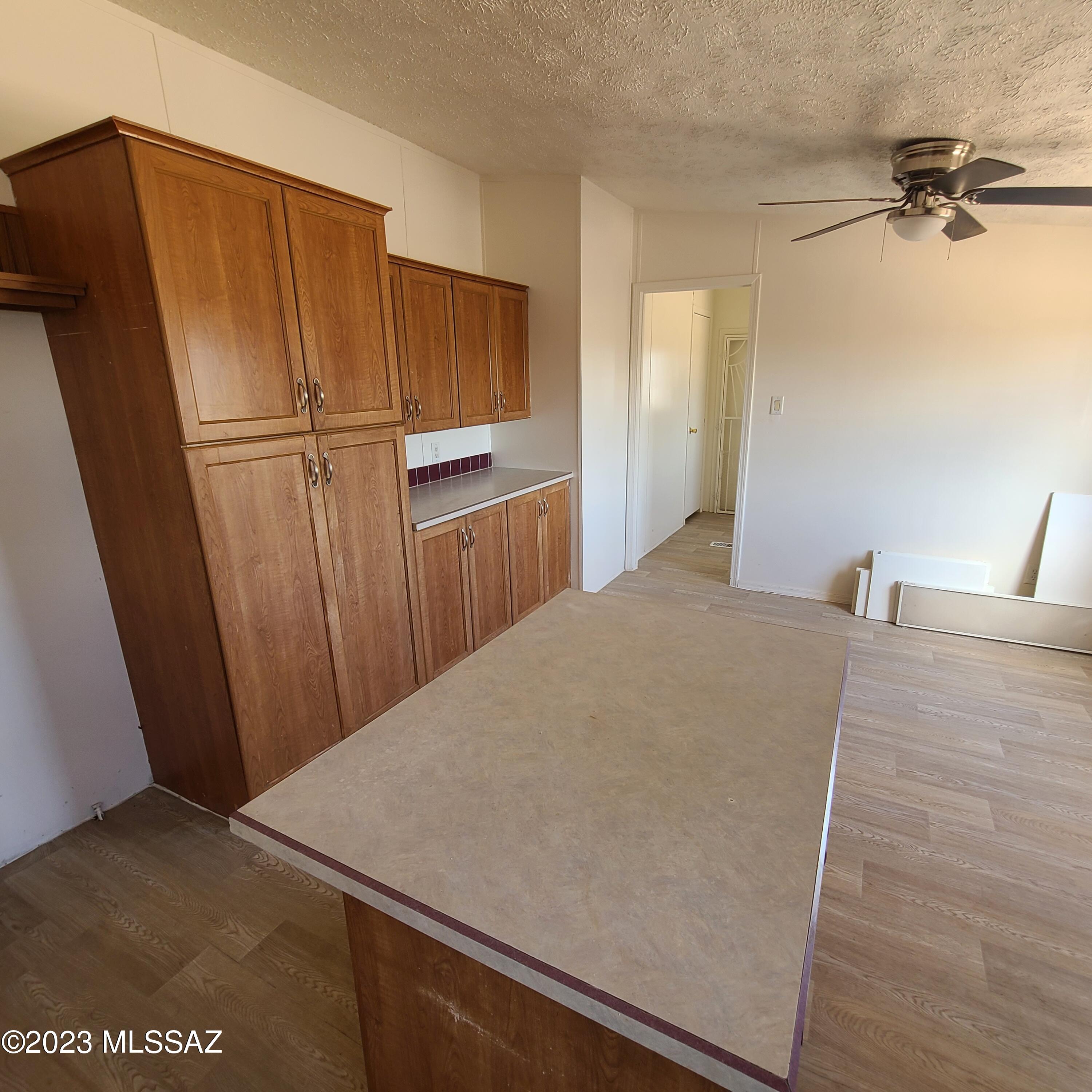 8896 South Marstellar Road Tucson, AZ 85736 - Photo 13 of 39 a bedroom with a bed and a refrigerator