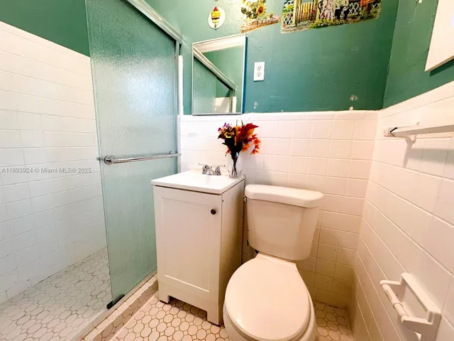 a white toilet sitting next to a bathroom sink