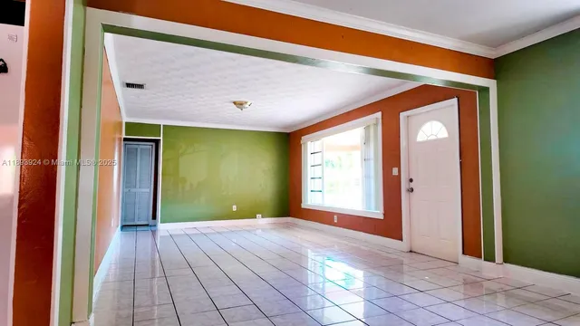 a view of a hallway with wooden floor and a window