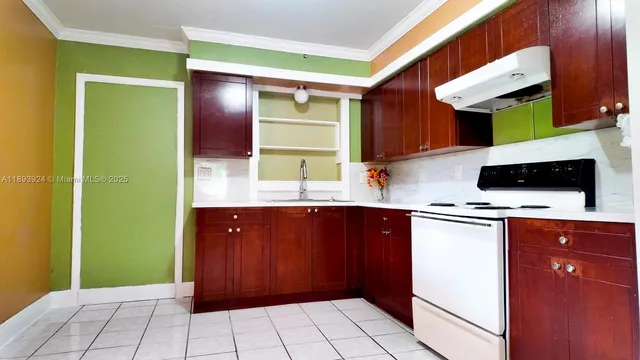 a kitchen with stainless steel appliances granite countertop a sink and a refrigerator