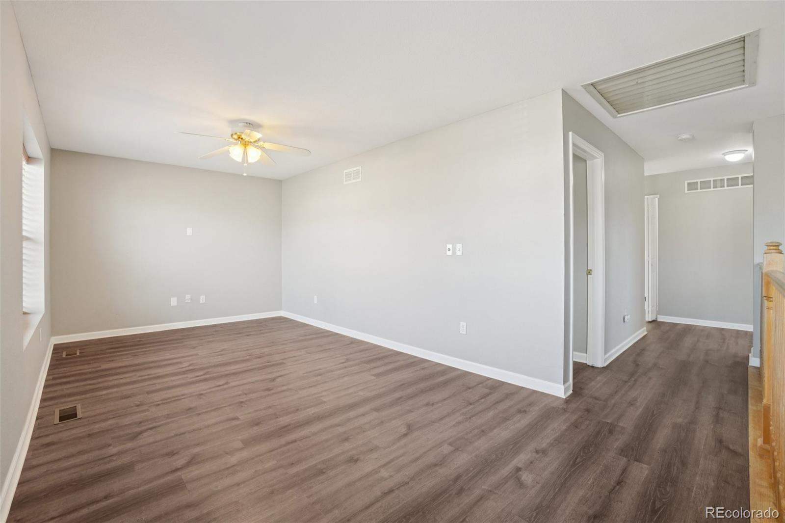 11205 Coal Ridge Street Firestone, CO 80504 - Photo 16 of 40 a view of an empty room and wooden floor