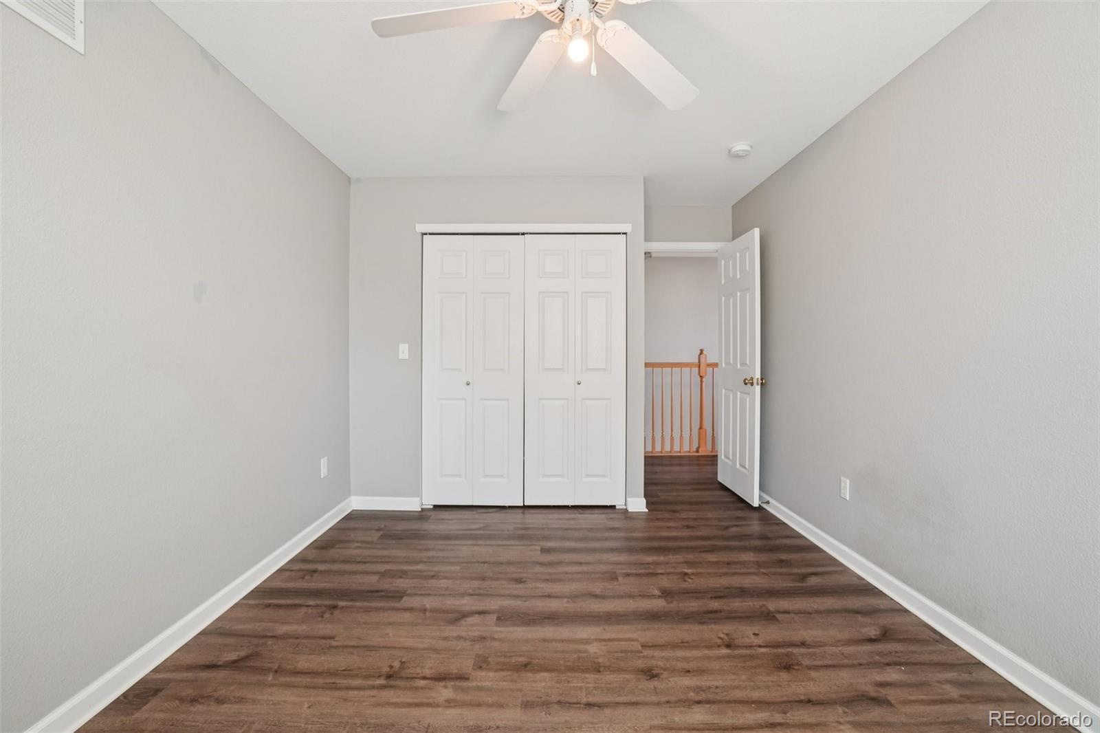 11205 Coal Ridge Street Firestone, CO 80504 - Photo 18 of 40 a view of an empty room with wooden floor