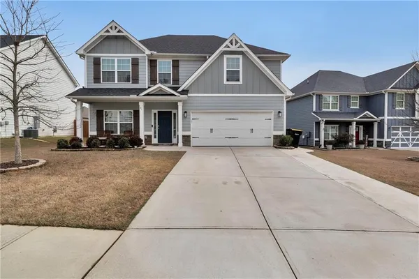 a view of a white house with large windows