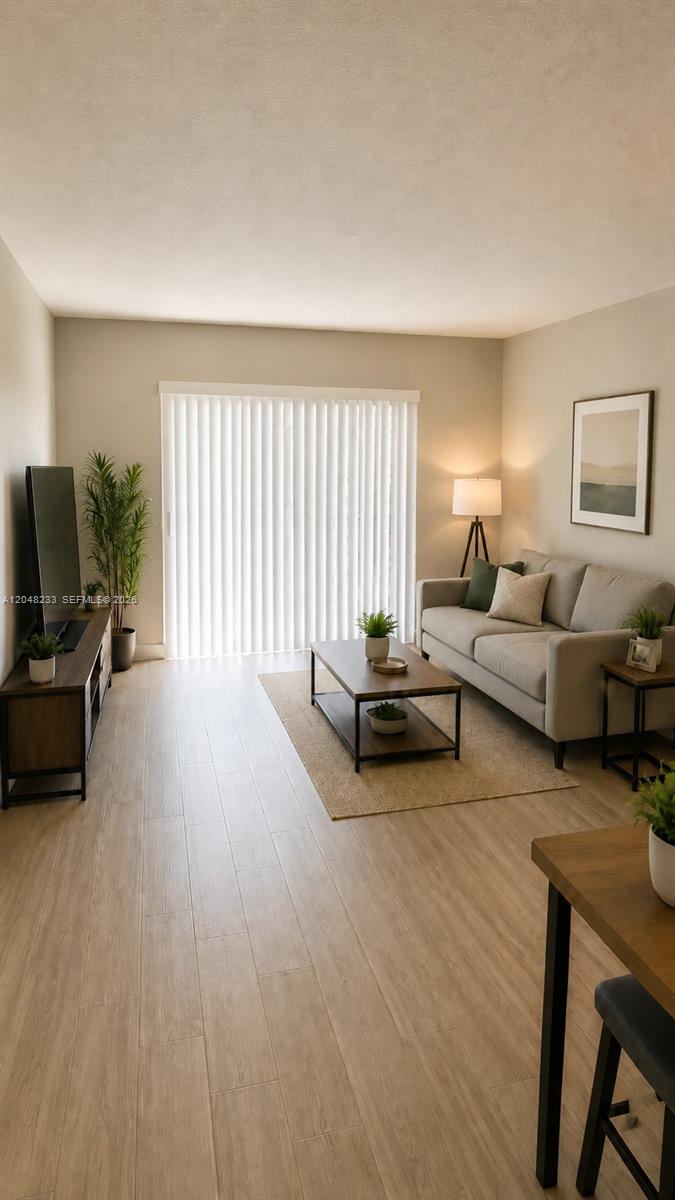 1530 Southwest 2nd Street, Unit 307 Miami, FL 33135 - Photo 5 of 7 a living room with furniture and a flat screen tv