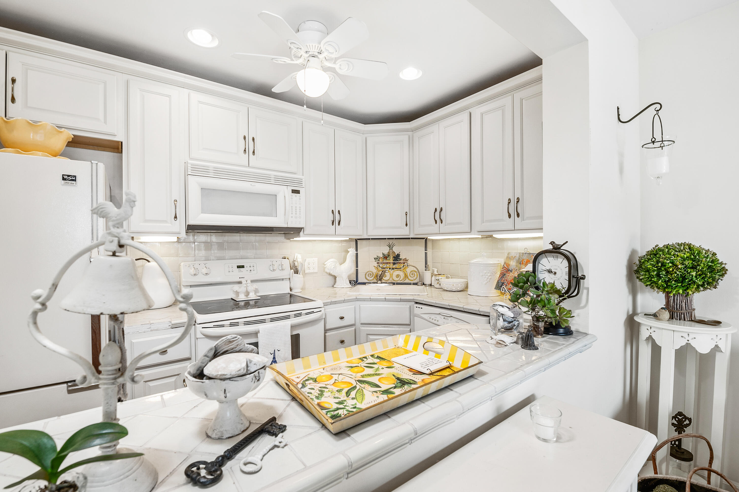 3375 Foothill Road, Unit 412 Carpinteria, CA 93013 - Photo 12 of 22 a kitchen with stainless steel appliances a white stove top oven a sink a counter space and cabinets