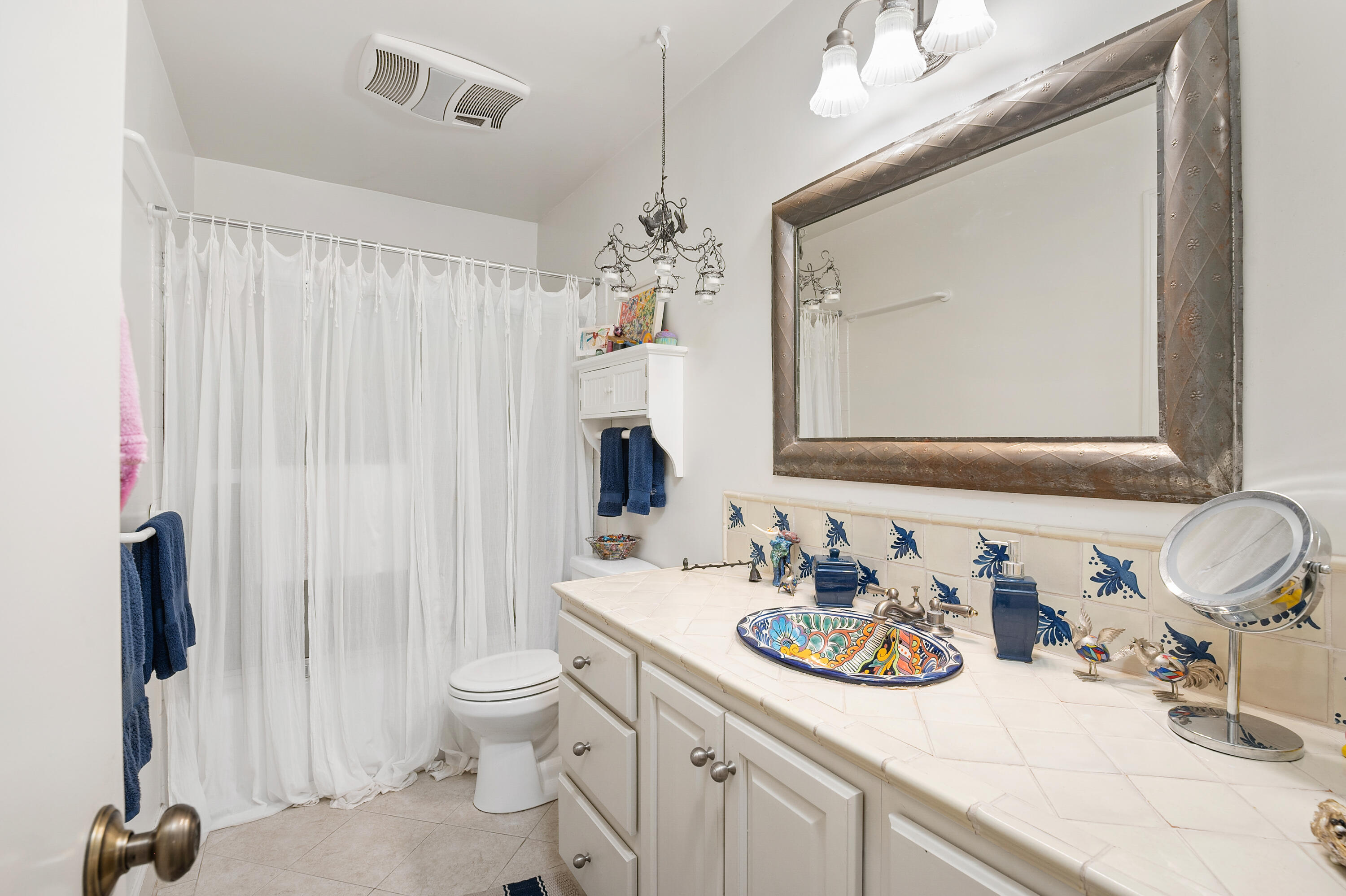 3375 Foothill Road, Unit 412 Carpinteria, CA 93013 - Photo 15 of 22 a bathroom with a sink a toilet and a mirror