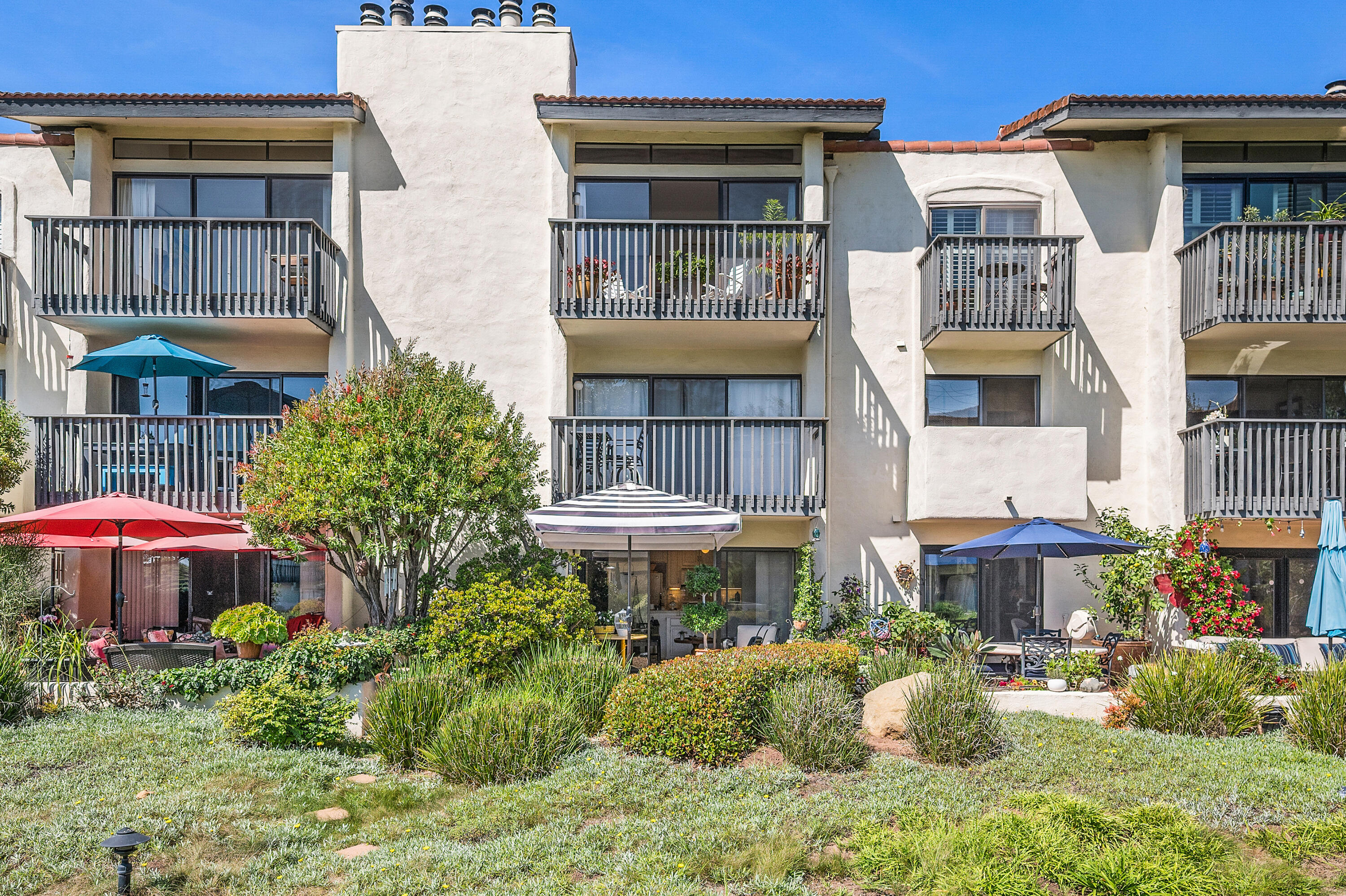 3375 Foothill Road, Unit 412 Carpinteria, CA 93013 - Photo 19 of 22 a front view of a building with a garden and plants