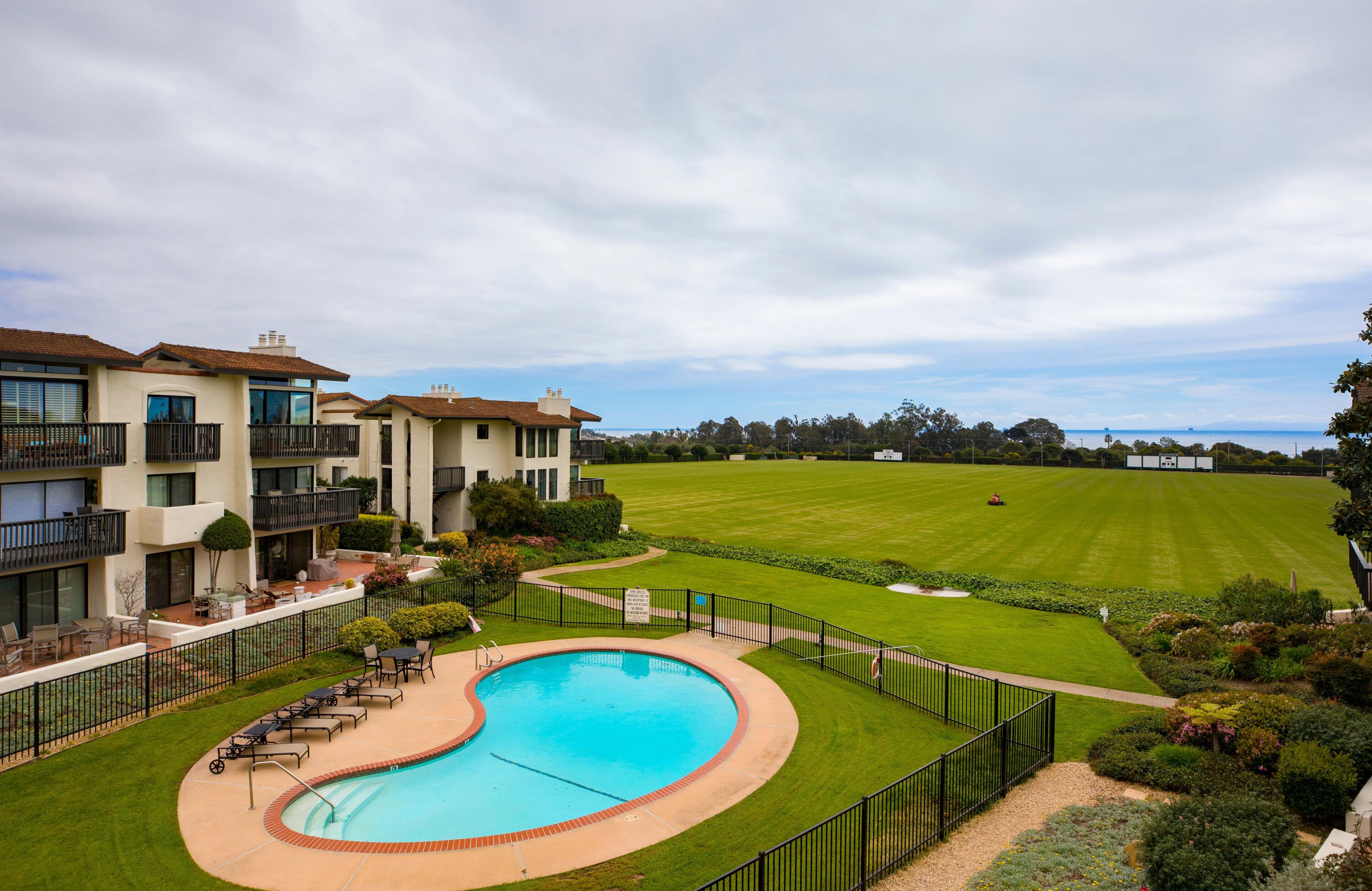 3375 Foothill Road, Unit 412 Carpinteria, CA 93013 - Photo 2 of 22 a view of a swimming pool with an outdoor seating