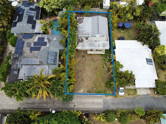an aerial view of a house with a yard and garden