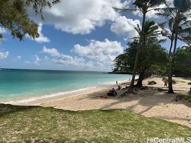 a view of a lake with lawn chairs