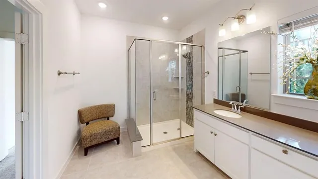 a bathroom with a double vanity sink toilet mirror and shower