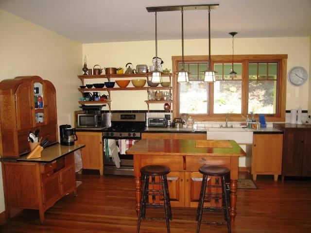 99 Hupi Road Monterey, MA 01245 - Photo 9 of 20 a view of a kitchen with kitchen island granite countertop wooden floor and a large window