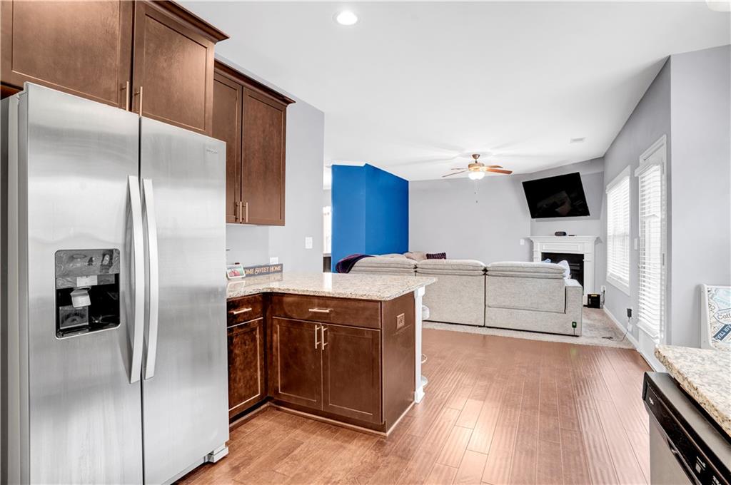 7789 Village Pass Fairburn, GA 30213 - Photo 15 of 35 a kitchen with stainless steel appliances a refrigerator sink and cabinets