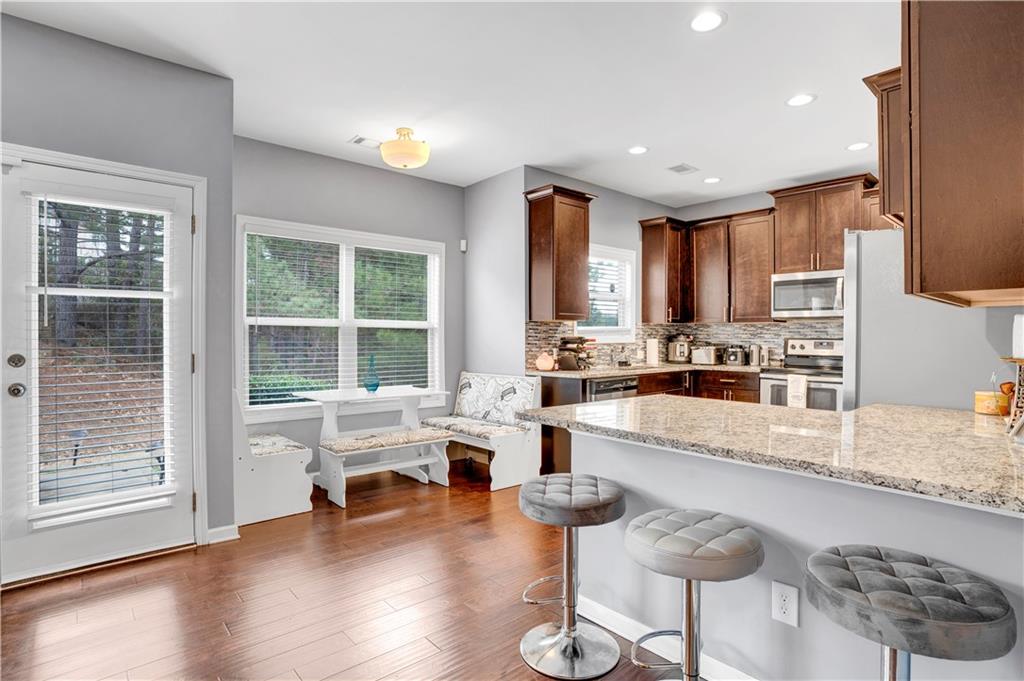 7789 Village Pass Fairburn, GA 30213 - Photo 16 of 35 a kitchen with sink refrigerator and cabinets
