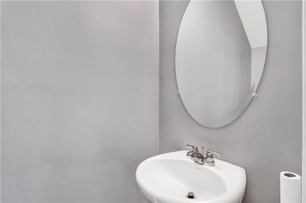 7789 Village Pass Fairburn, GA 30213 - Photo 21 of 35 a bathroom with a sink and a mirror