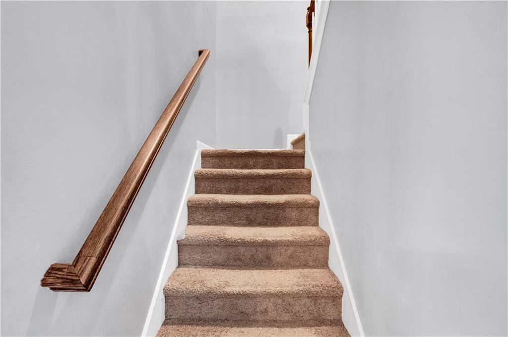 7789 Village Pass Fairburn, GA 30213 - Photo 22 of 35 a view of staircase with white walls