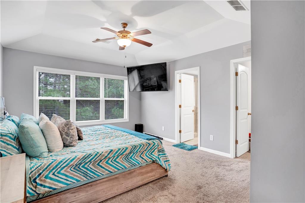 7789 Village Pass Fairburn, GA 30213 - Photo 25 of 35 a bedroom with a large bed and a window