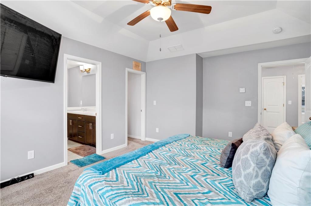 7789 Village Pass Fairburn, GA 30213 - Photo 26 of 35 a bedroom with a bed and a flat tv screen