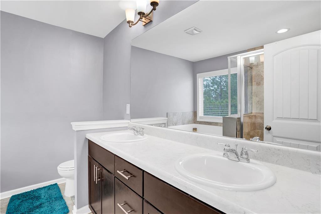 7789 Village Pass Fairburn, GA 30213 - Photo 27 of 35 a bathroom with a sink vanity and a mirror