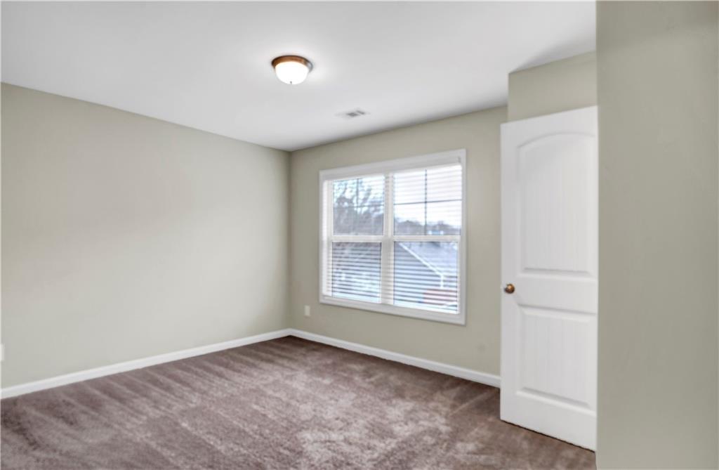 7789 Village Pass Fairburn, GA 30213 - Photo 30 of 35 an empty room with a window