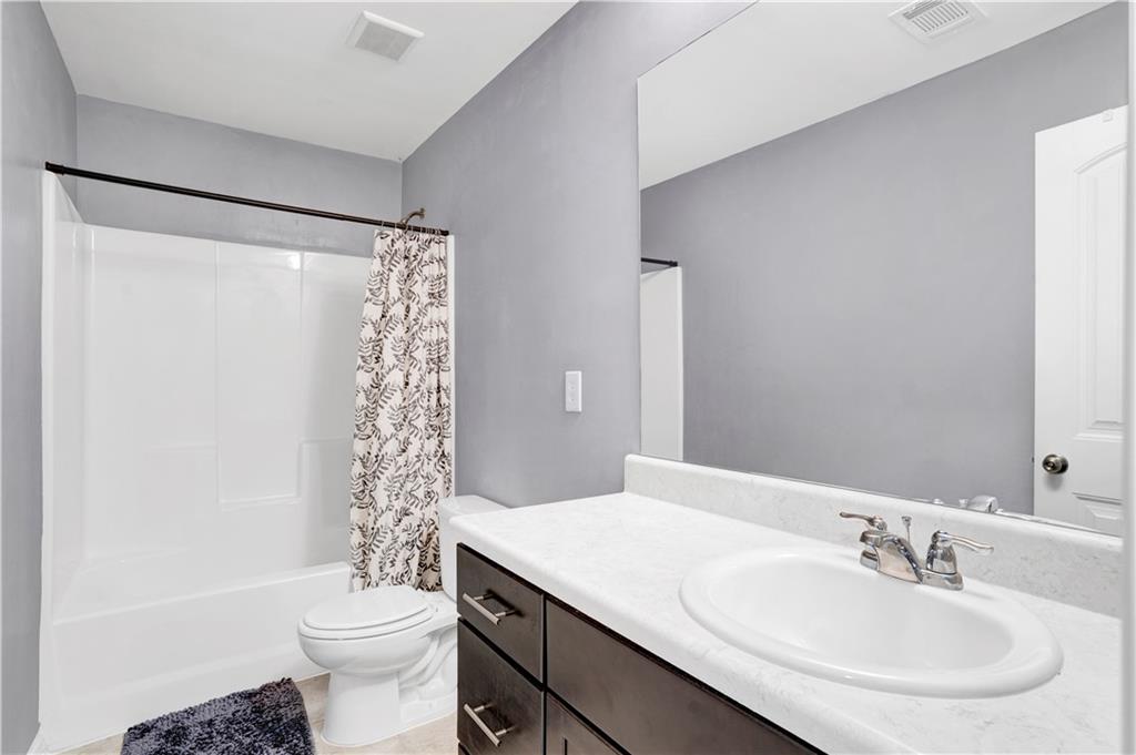 7789 Village Pass Fairburn, GA 30213 - Photo 35 of 35 a bathroom with a sink toilet and shower