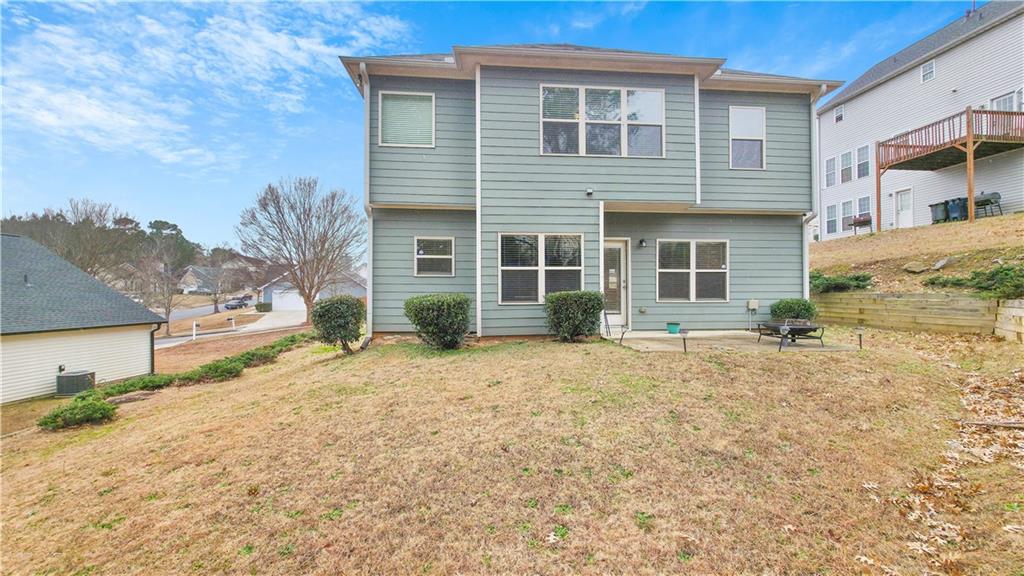 7789 Village Pass Fairburn, GA 30213 - Photo 4 of 35 a front view of a house with a yard and garage